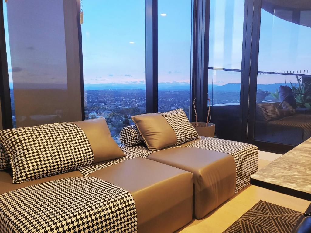 a living room with a couch and some windows at Modern&cozy life in Sky Garden 5min from station in Glen Waverley