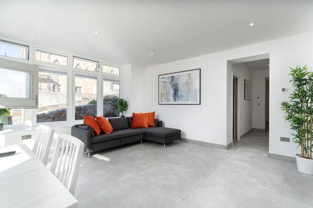 a living room with a couch and a table at Stunning new 1 bed apartment in Marazion. in Marazion