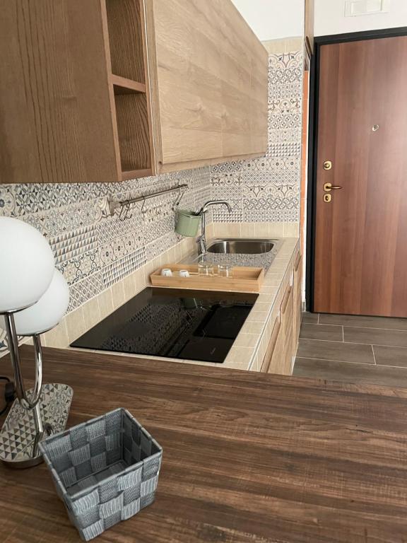 a kitchen with a sink in the middle of it at Casa vacanze San Francesco in Barletta