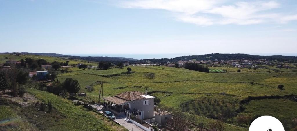 an aerial view of a house in a green field at Farmhouse in Volímai