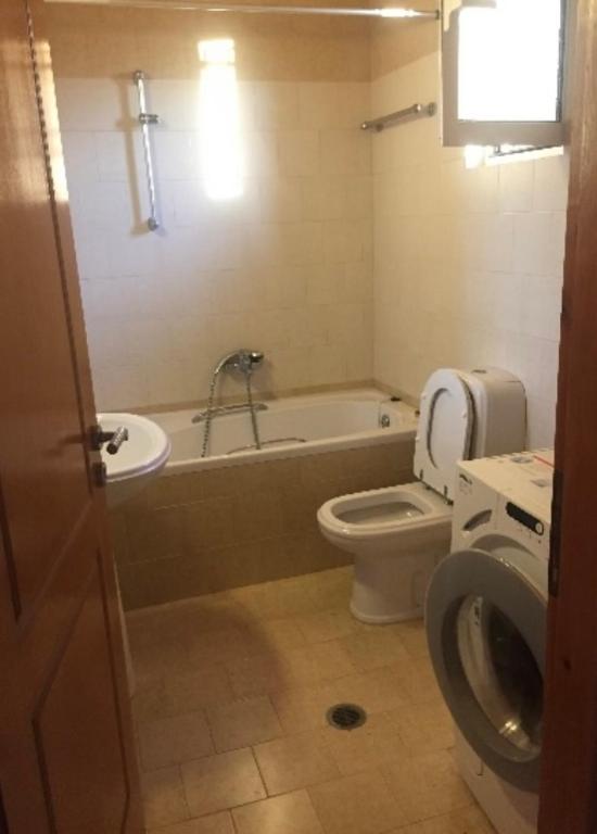 a bathroom with a tub and a toilet and a sink at Farmhouse in Volímai