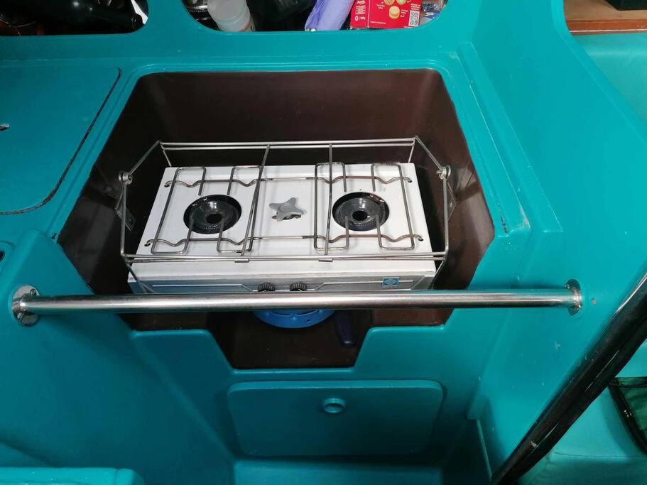 a stove top oven sitting inside of a blue box at Dormir sur un bateau in Cap d'Agde