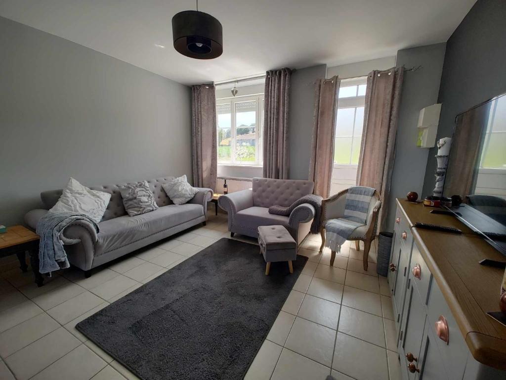 a living room with a couch and two chairs at Perfect Gites In Normandy 