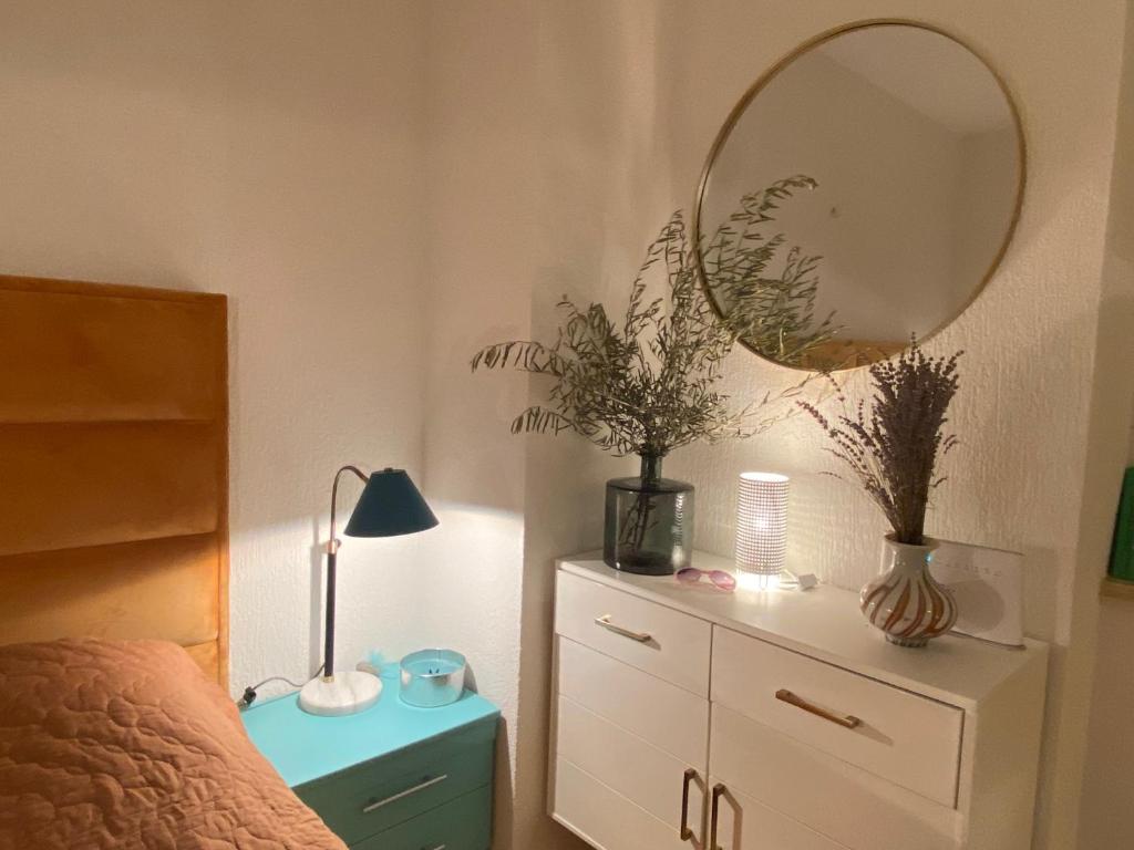 a bedroom with a mirror and a dresser and a bed at Villa Yucca Istra in Labin
