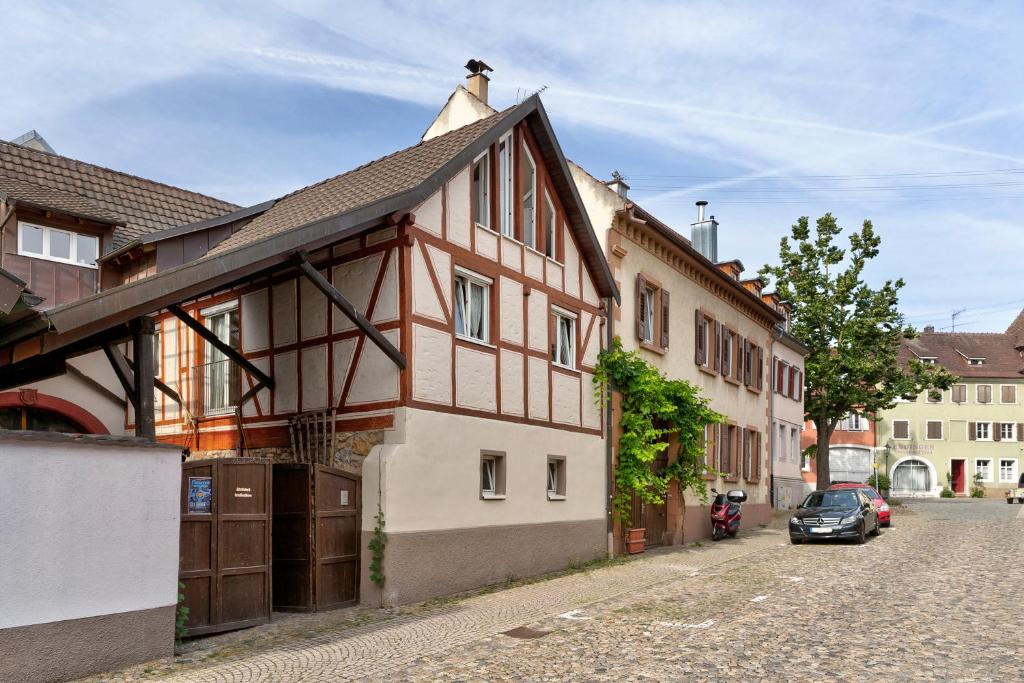 un edificio en una calle con un coche aparcado al lado en Miris Hüs, en Endingen am Kaiserstuhl