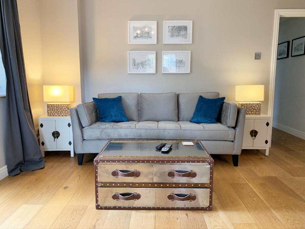 a living room with a couch and blue pillows at Stylish Two-Bedroom Apartments in Windsor in Windsor