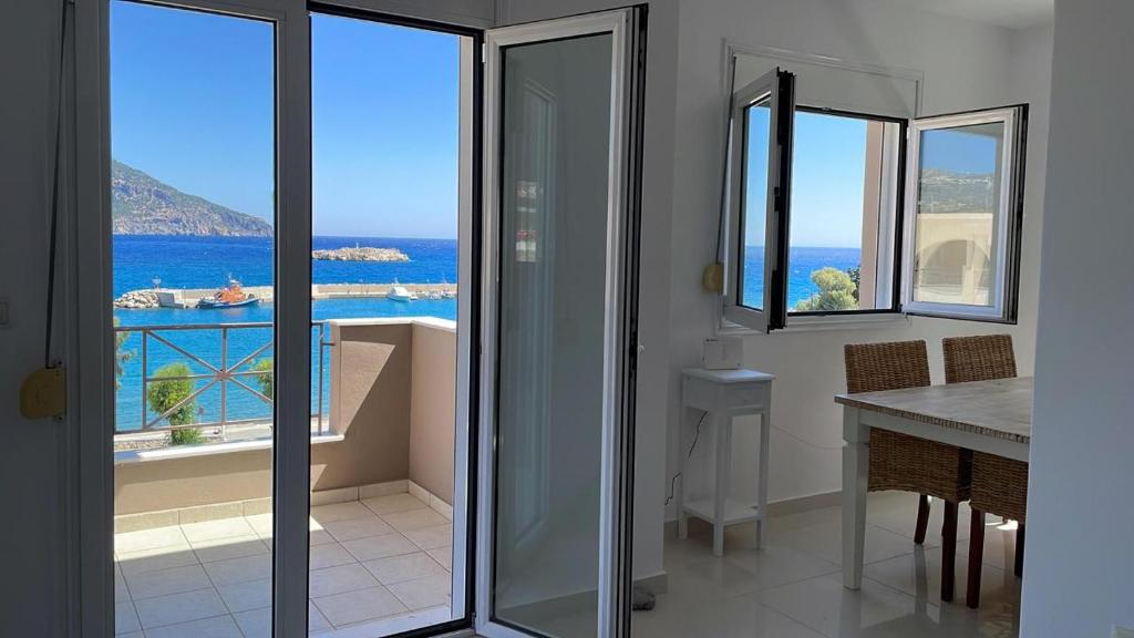 a room with a view of the ocean from a house at Locals Apartment Karpathos in Karpathos Town