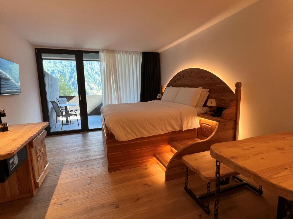 Postel nebo postele na pokoji v ubytování Hotel Chalet Al Foss