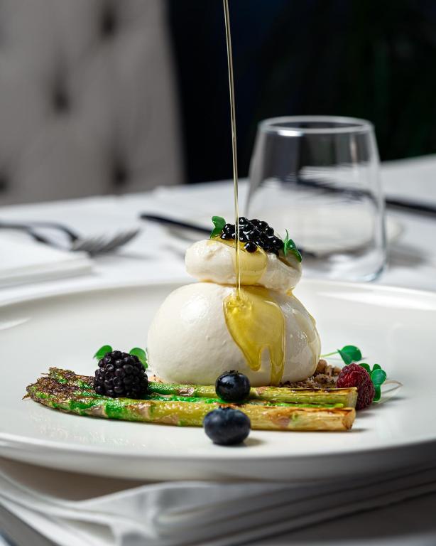 a dessert on a white plate on a table at Hotel California by Aycon in Sveti Stefan