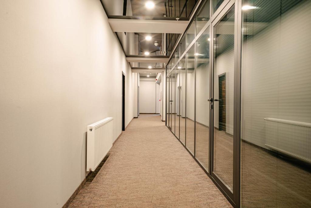 a corridor of an office building with a long hallway at Bakuriani Inn in Bakuriani