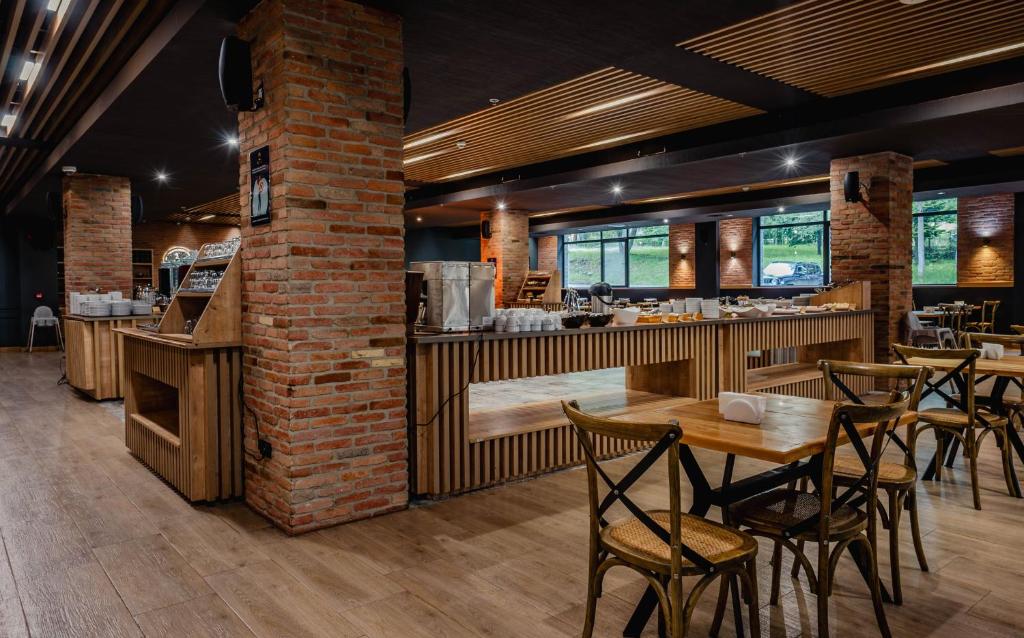 a restaurant with tables and chairs and a bar at Bakuriani Inn in Bakuriani