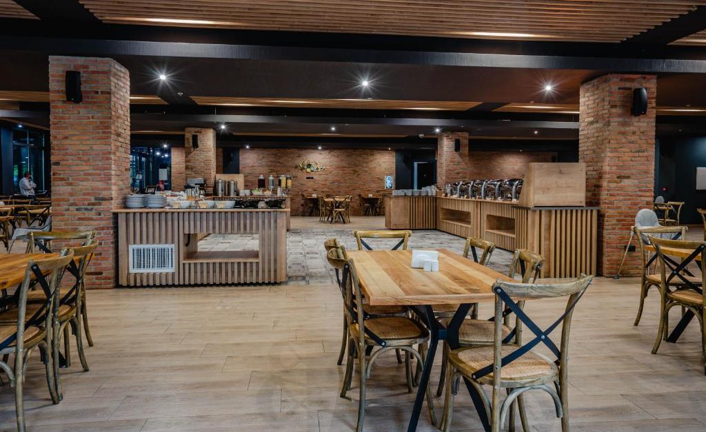 a restaurant with brick walls and tables and chairs at Bakuriani Inn in Bakuriani