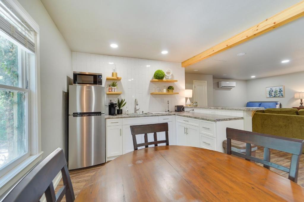 a kitchen with a refrigerator and a table and chairs at Amarillo Vacation Rental with Shared Pool! in Amarillo
