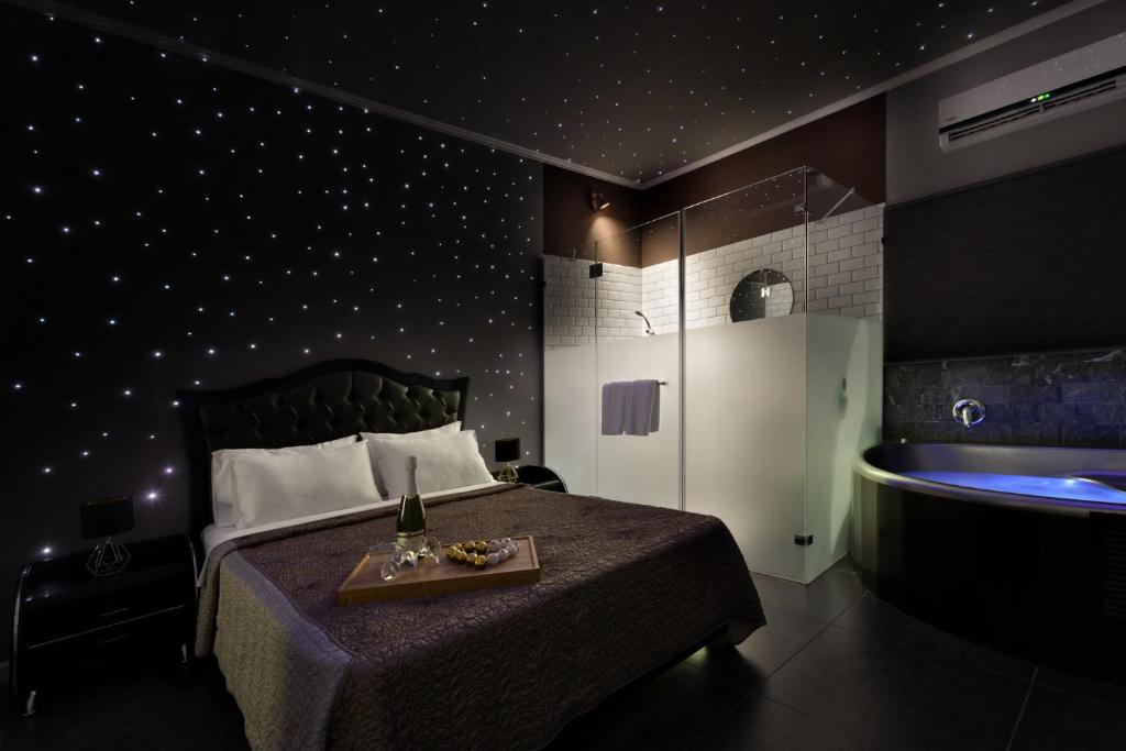 a bedroom with a bed and a tub in it at Metro Elegance Suites in Tel Binyamin