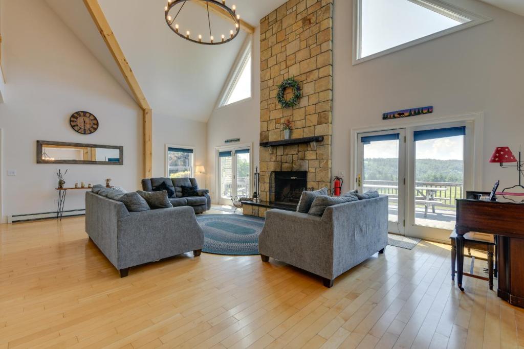 a living room with two couches and a piano at Secluded Calais Getaway Deck, Hot Tub and More! 