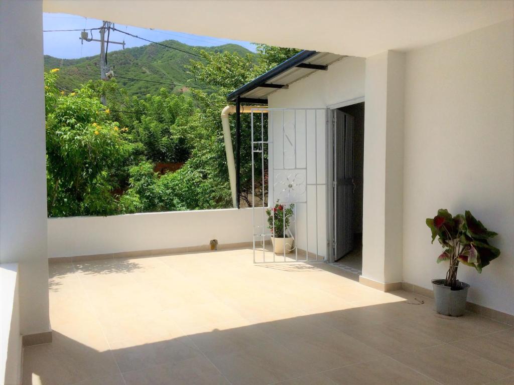a room with a window with a view of a mountain at GiGi House Taganga in Taganga