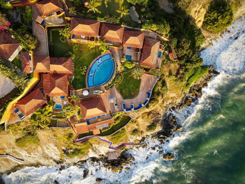 an aerial view of a house on the beach at Cala Margarita Hotel in Paraguachi