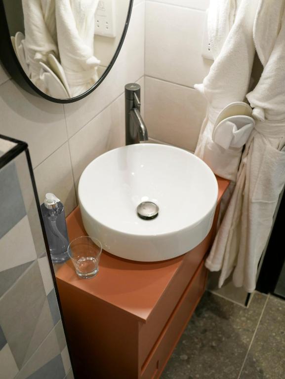 a bathroom with a white sink and a mirror at Eleven by Warren Collection in Sliema