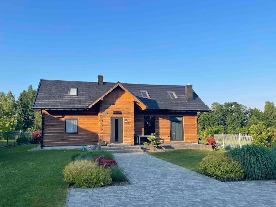 a wooden house with a pathway in front of it at Grand Rozbój House Beskid Niski, Spa Ogrodowe 