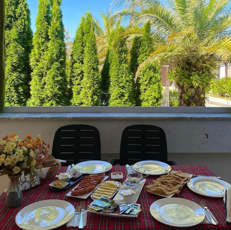 a table with plates of food on top of a table at Grigoleti River Club in Maltakva