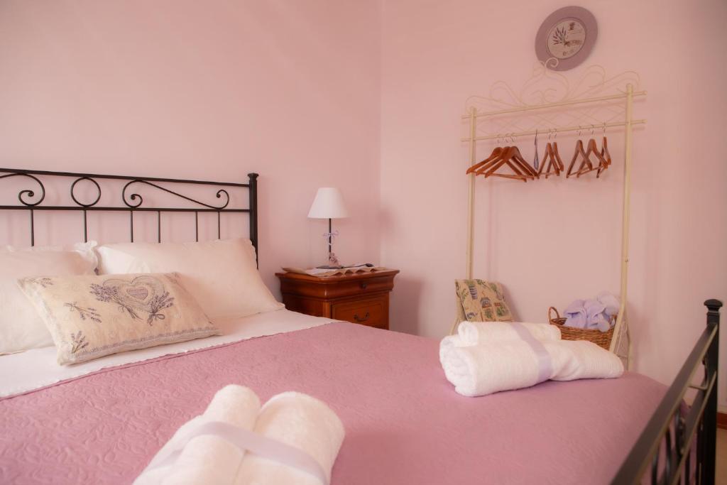 um quarto com uma cama e um relógio na parede em La Casa del Gelsomino em Acquaviva Picena