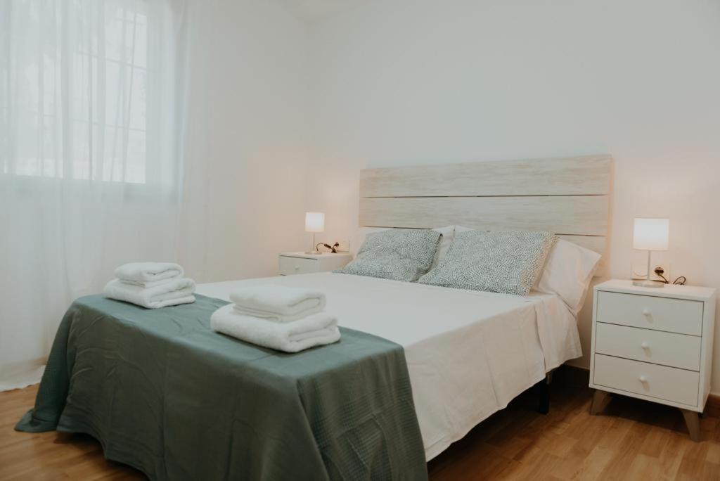 a bedroom with a bed with towels on a table at Vimar Algarrobo Costa in Algarrobo-Costa