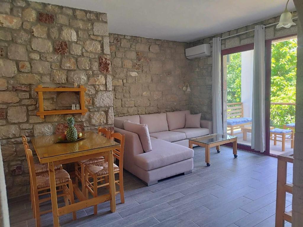 a living room with a couch and a table at Tropical Garden Prime Accommodation in Faliraki