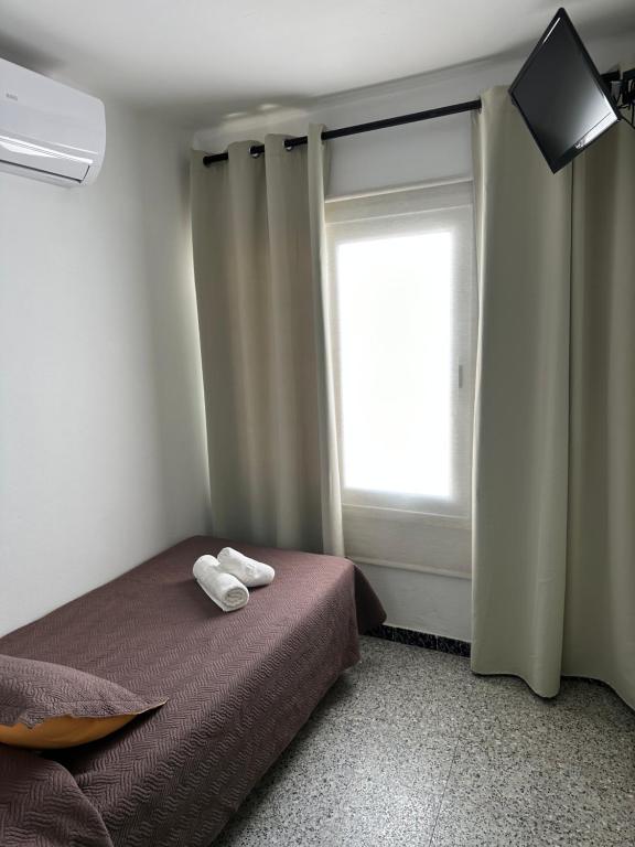 Postel nebo postele na pokoji v ubytování L'Illa Hotel