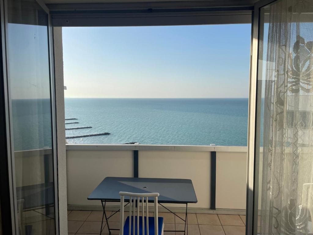 a balcony with a table and a view of the ocean at ATTICO VISTA MARE in Misano Adriatico