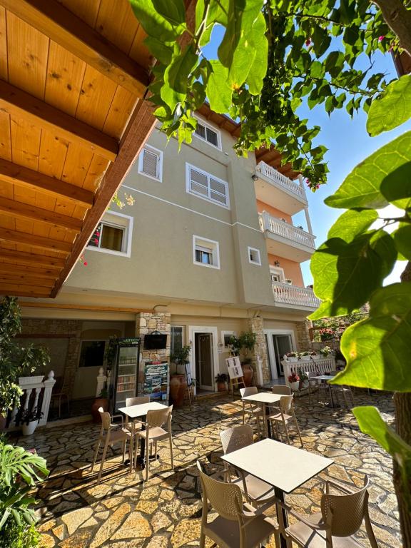 a patio with tables and chairs in front of a building at Vila Arial in Vlorë