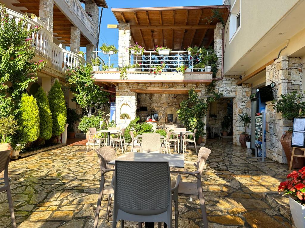 a patio with tables and chairs in a building at Vila Arial in Vlorë