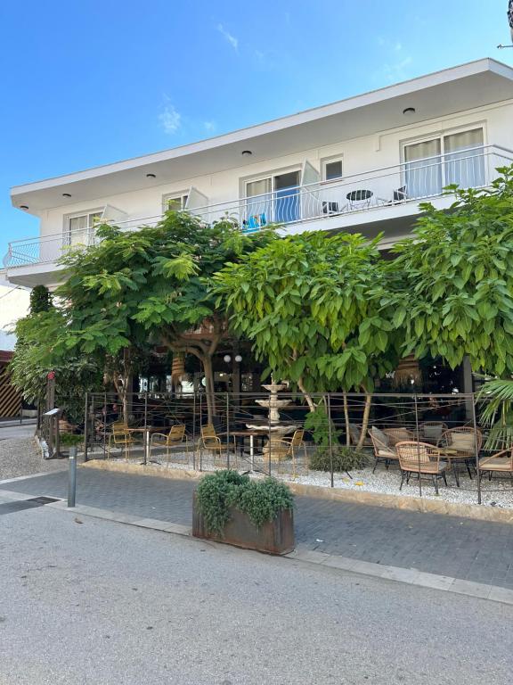 a building with a lot of trees in front of it at Hotel L'Illa in Tossa de Mar