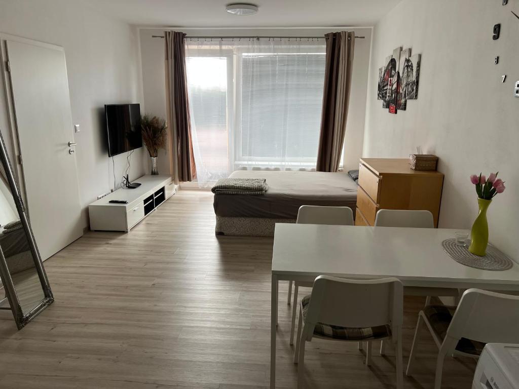 a living room with a bed and a dining room table at Beautiful 2 Bedroom Apartment in Prostějov