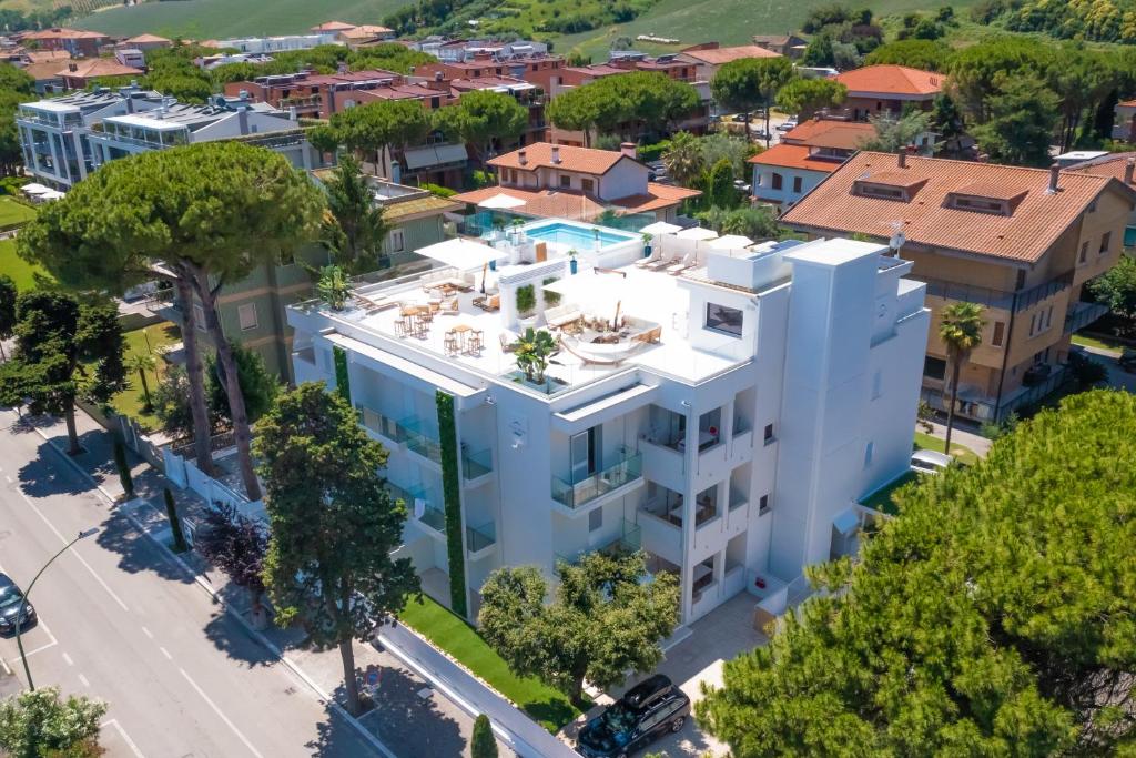 an aerial view of a white building with a pool at Villa Mare Pineto in Pineto