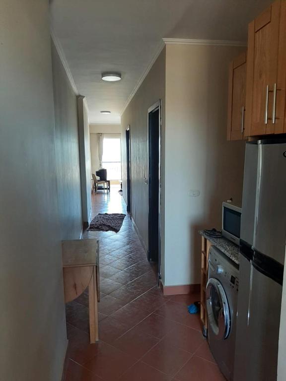 A kitchen or kitchenette at Porto Residence Chalet, Outside Marina Gate 3, Sahel North Coast For Rent - شاليه بورتورسيدنس بخارج بوابة 3 مارينا الساحل الإيجار