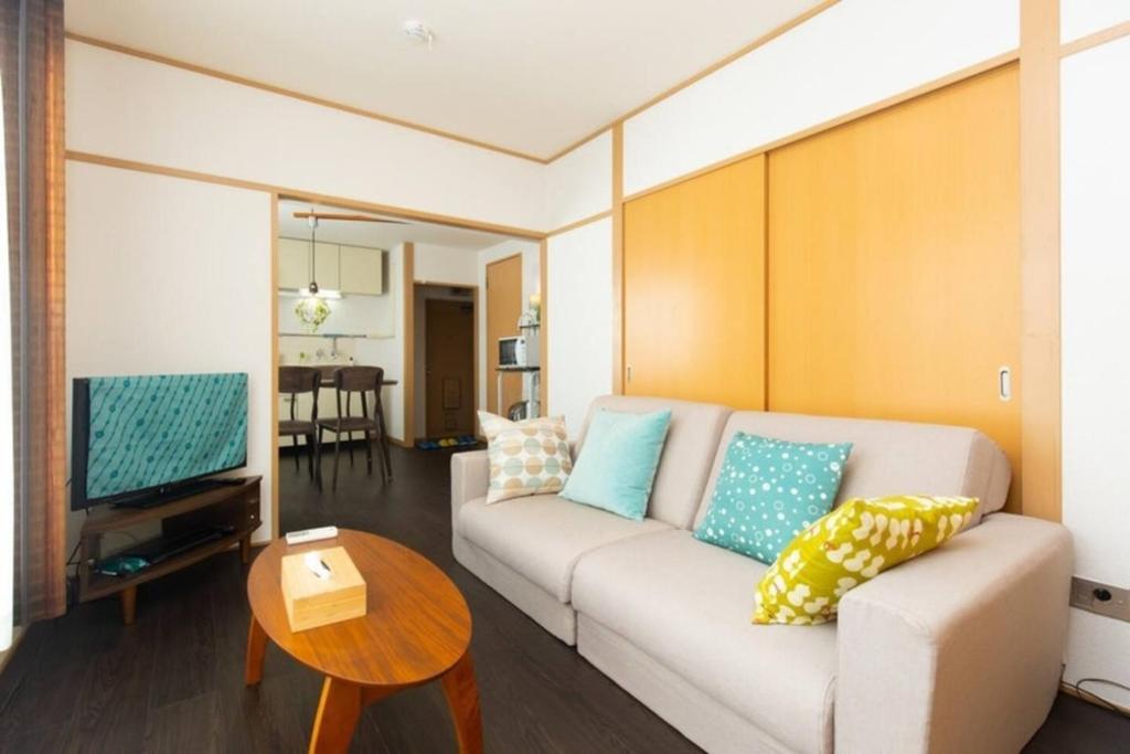 a living room with a couch and a table at Grace Heiwajima - Vacation STAY 15088 in Tokyo