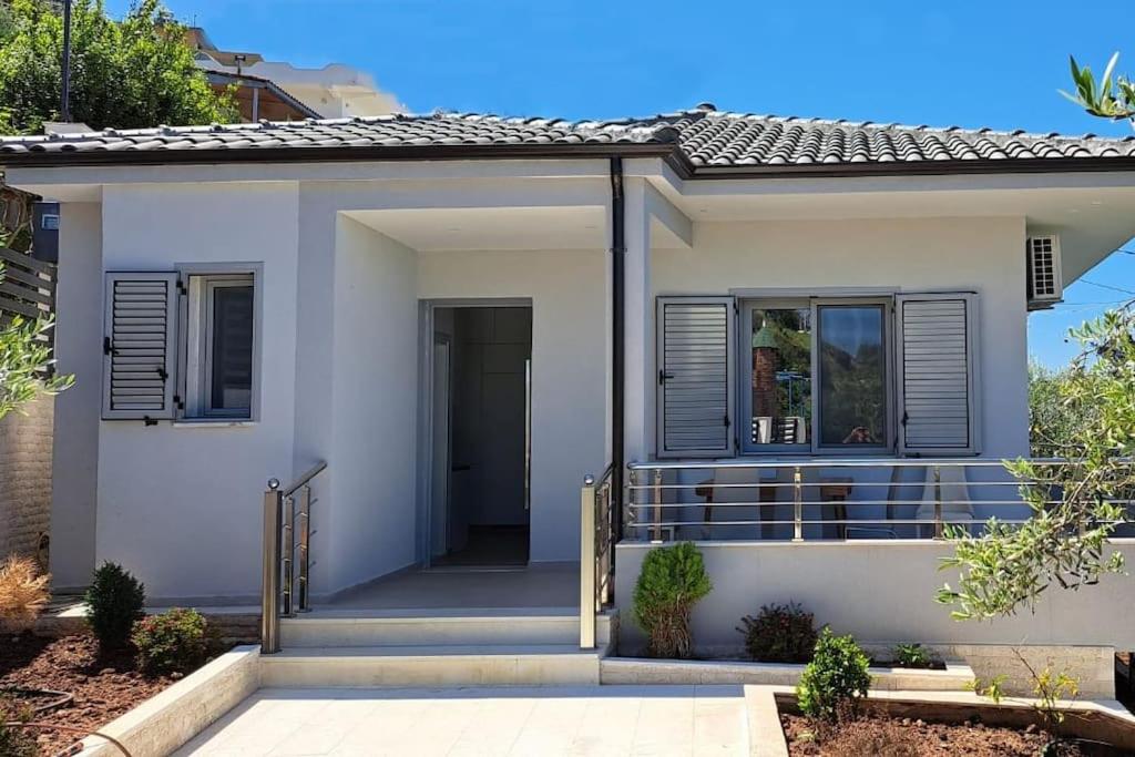 a white house with a porch and a door at Mimo’ s House in Vlorë