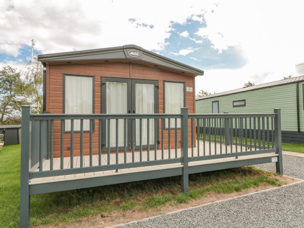 a tiny house with a fence around it at 20 Wolds View in Ganton
