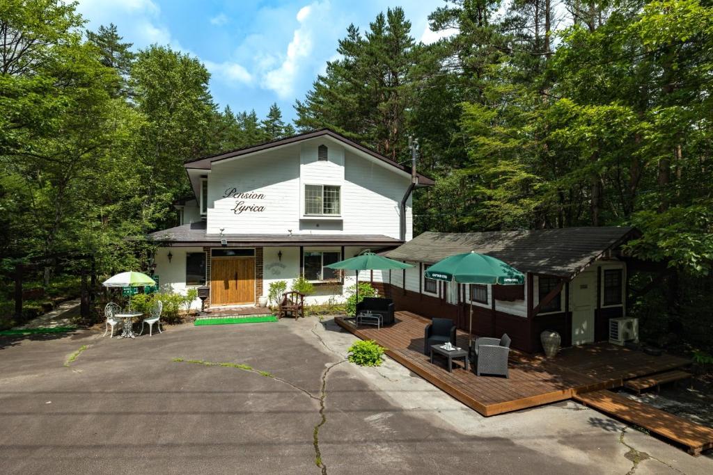 an aerial view of a white house with a patio at Mori no Komei campsite - Vacation STAY 04382v in Kita-karuizawa