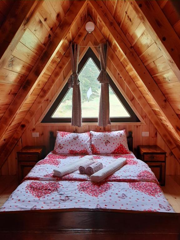 a bedroom with a bed in a attic at Wooden cottage Podgora in Žabljak
