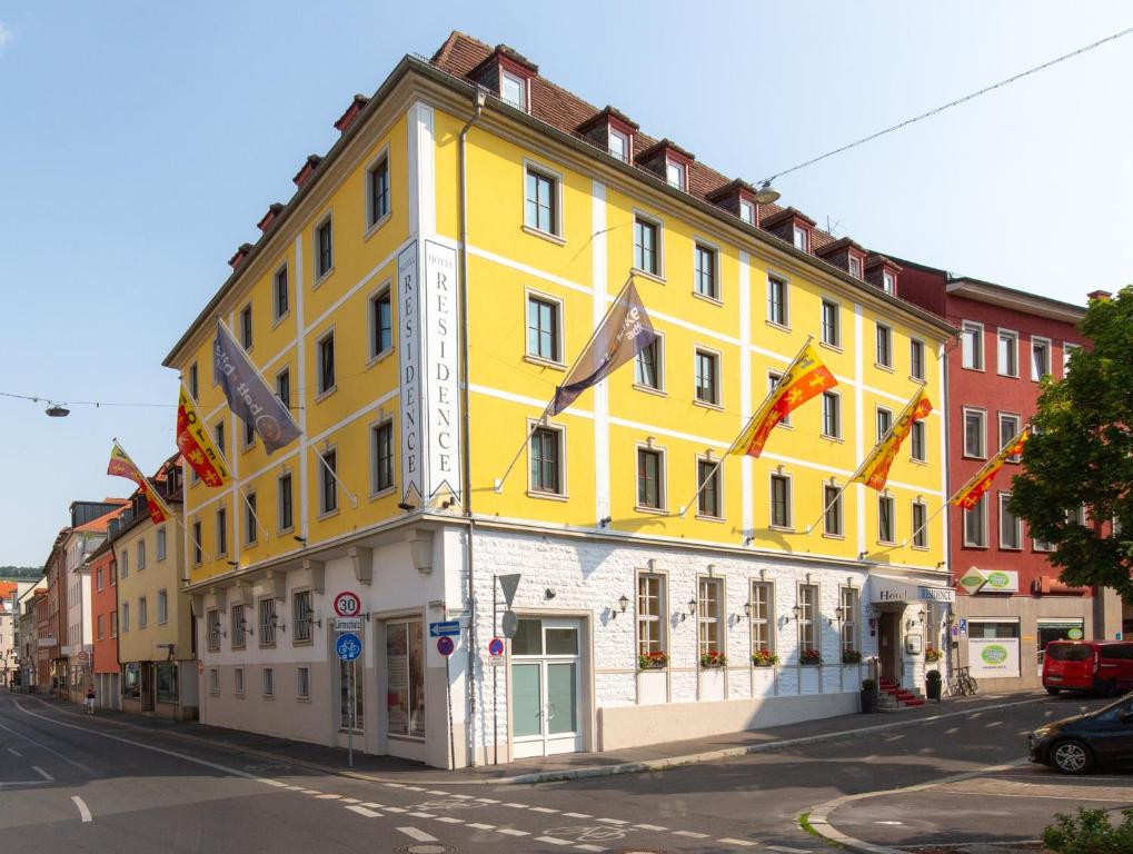 ein gelbes Gebäude an der Straßenseite in der Unterkunft Hotel Residence in Würzburg