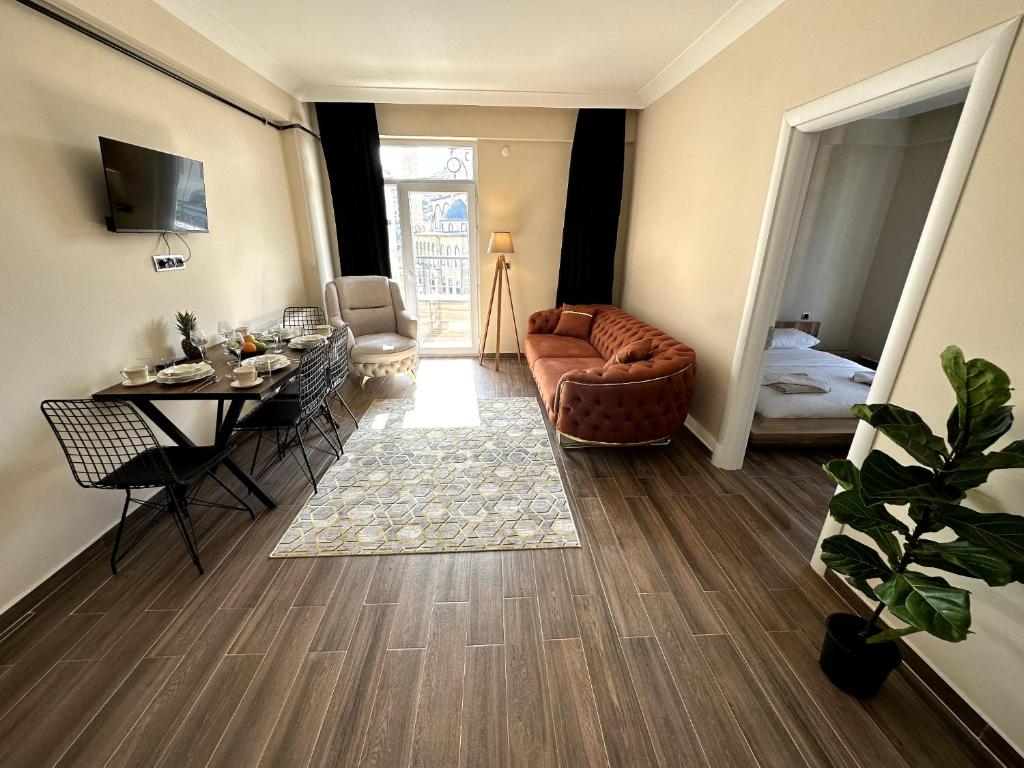 a living room with a couch and a table at THE SUİT Residence in Nevsehir