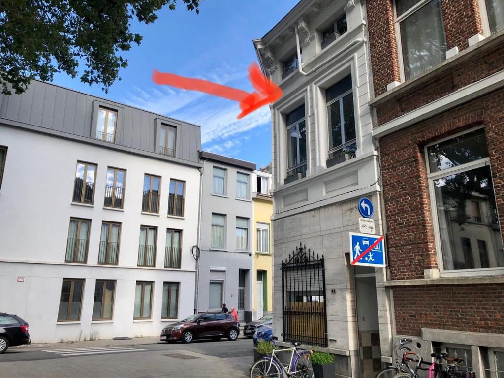 a red object is flying in the sky over buildings at cosy small FLAT in Antwerp near Justice Palace in Antwerp