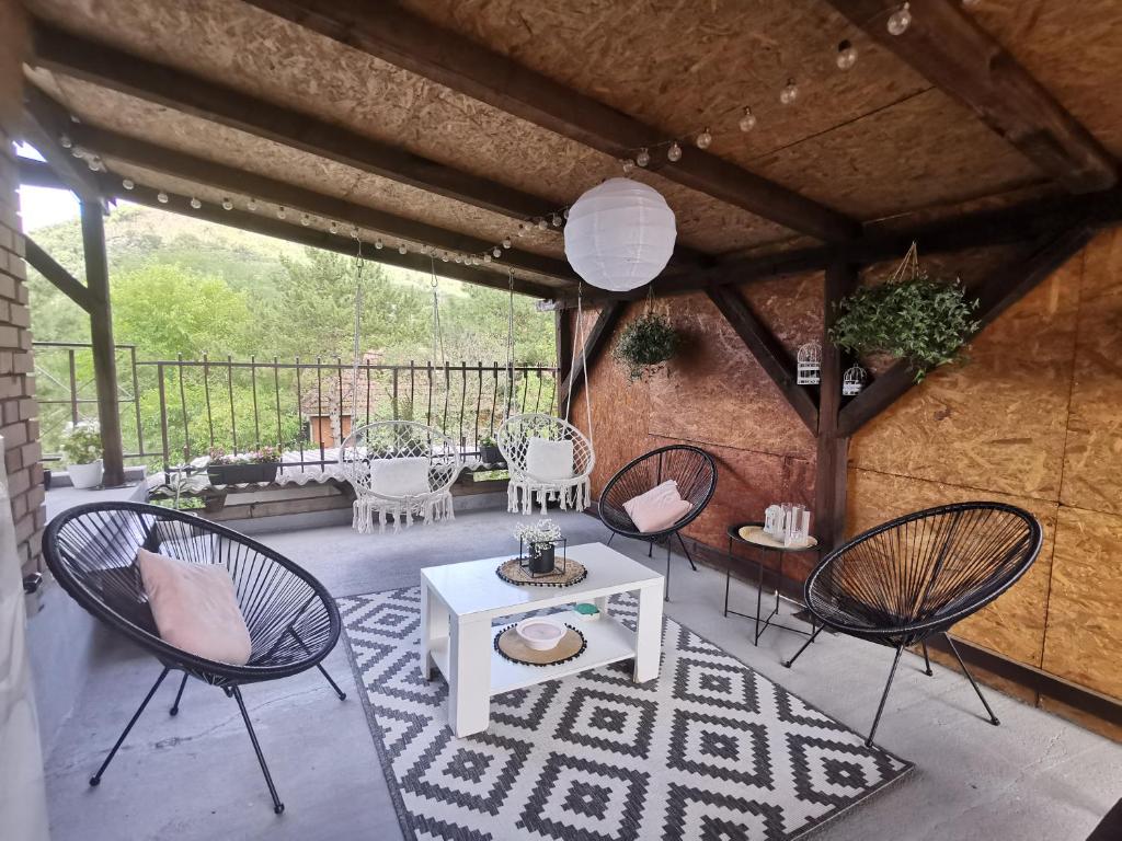 a patio with chairs and a table on a patio at Vikendica pod kulom in Vršac