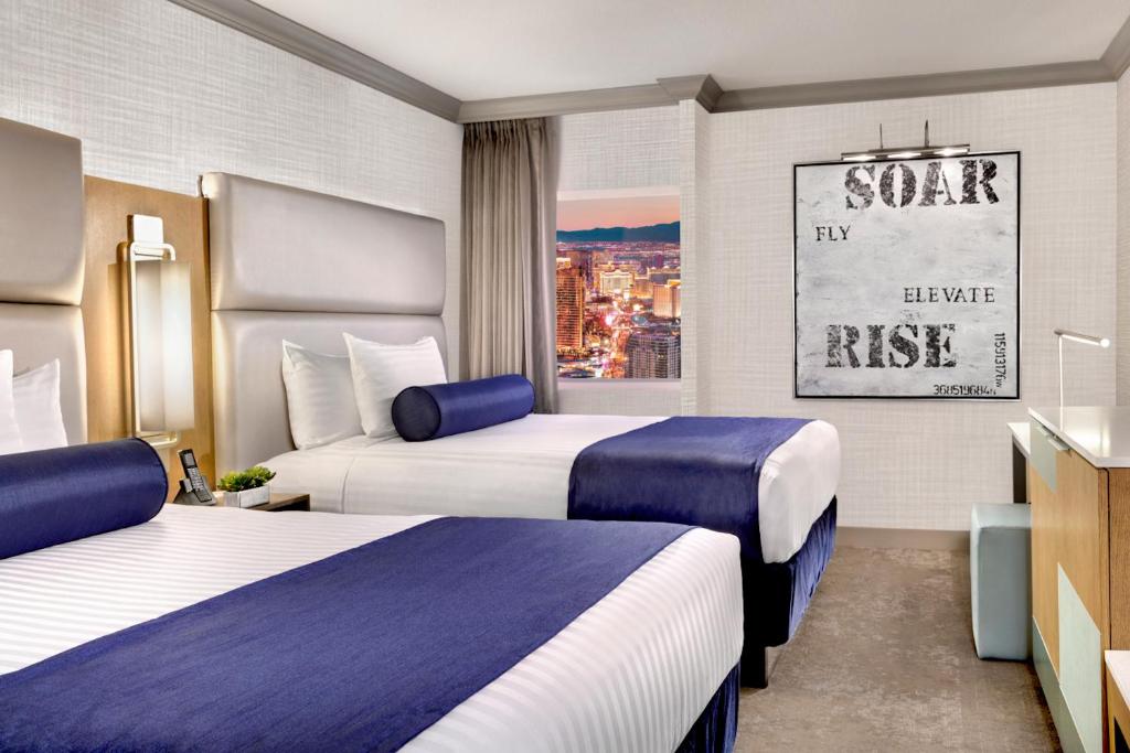 Enticing Stay at Strat Casino STRIP Las Vegas في لاس فيغاس: غرفة فندقية بسريرين ونافذة