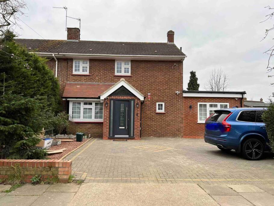 a brick house with a car parked in front of it at En-suite Double Room - Private Entrance & Free Parking in West Drayton