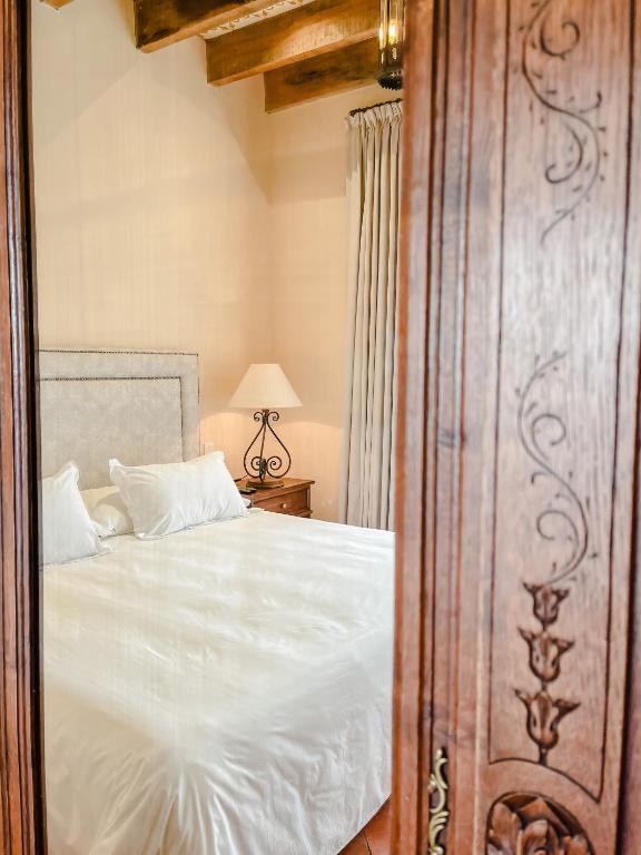 Postel nebo postele na pokoji v ubytování Hacienda Los Arcangeles