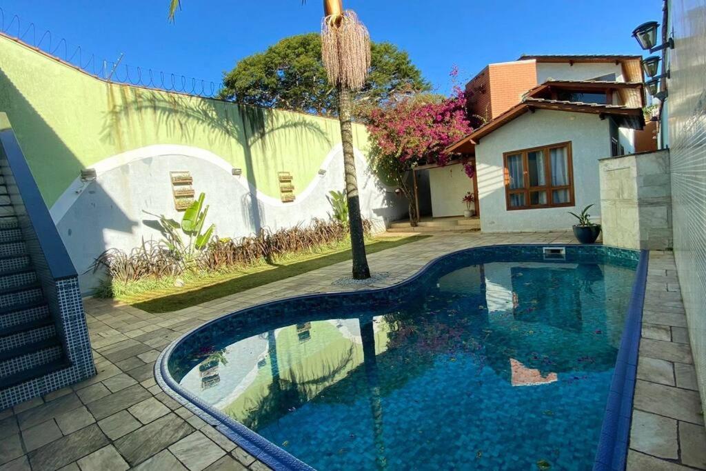 a swimming pool in front of a house at OPEN HOUSE VARGAS in Sao Paulo