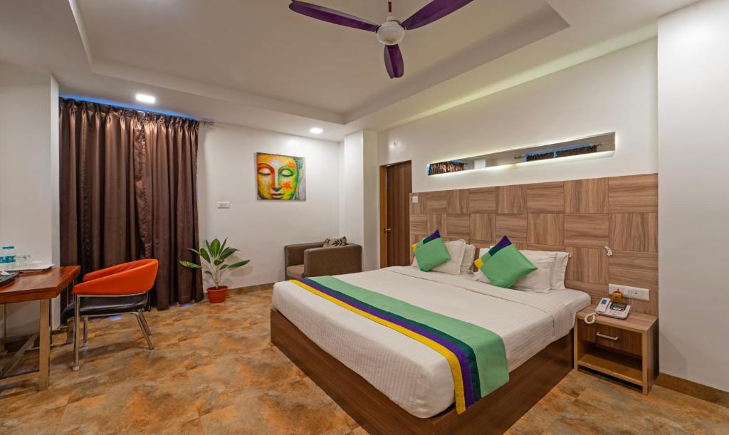 a hotel room with a bed and a desk at Treebo Trend Golden Swan Tambaram in Tambaram