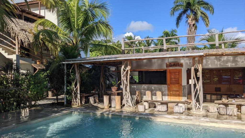 a resort with a swimming pool in front of a building at Residencia El Balatà in Las Terrenas